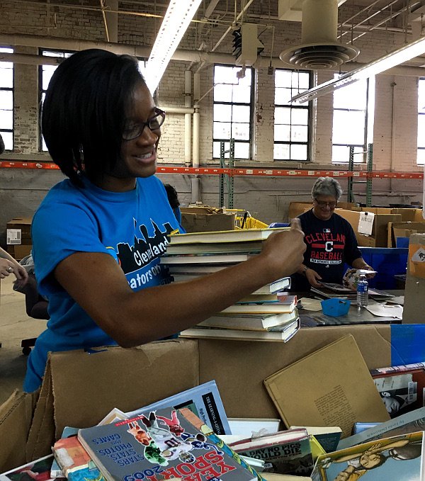 Volunteer sorting books at the Cleveland Kids' Book Bank