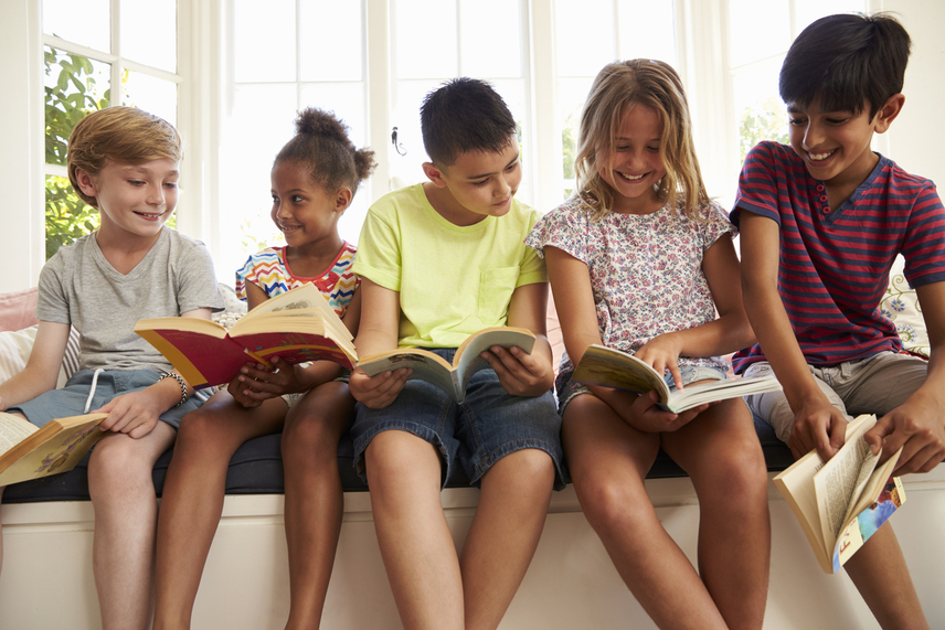 kids-sitting-in-front-of-window-reading photo of kids sitting in front of window reading