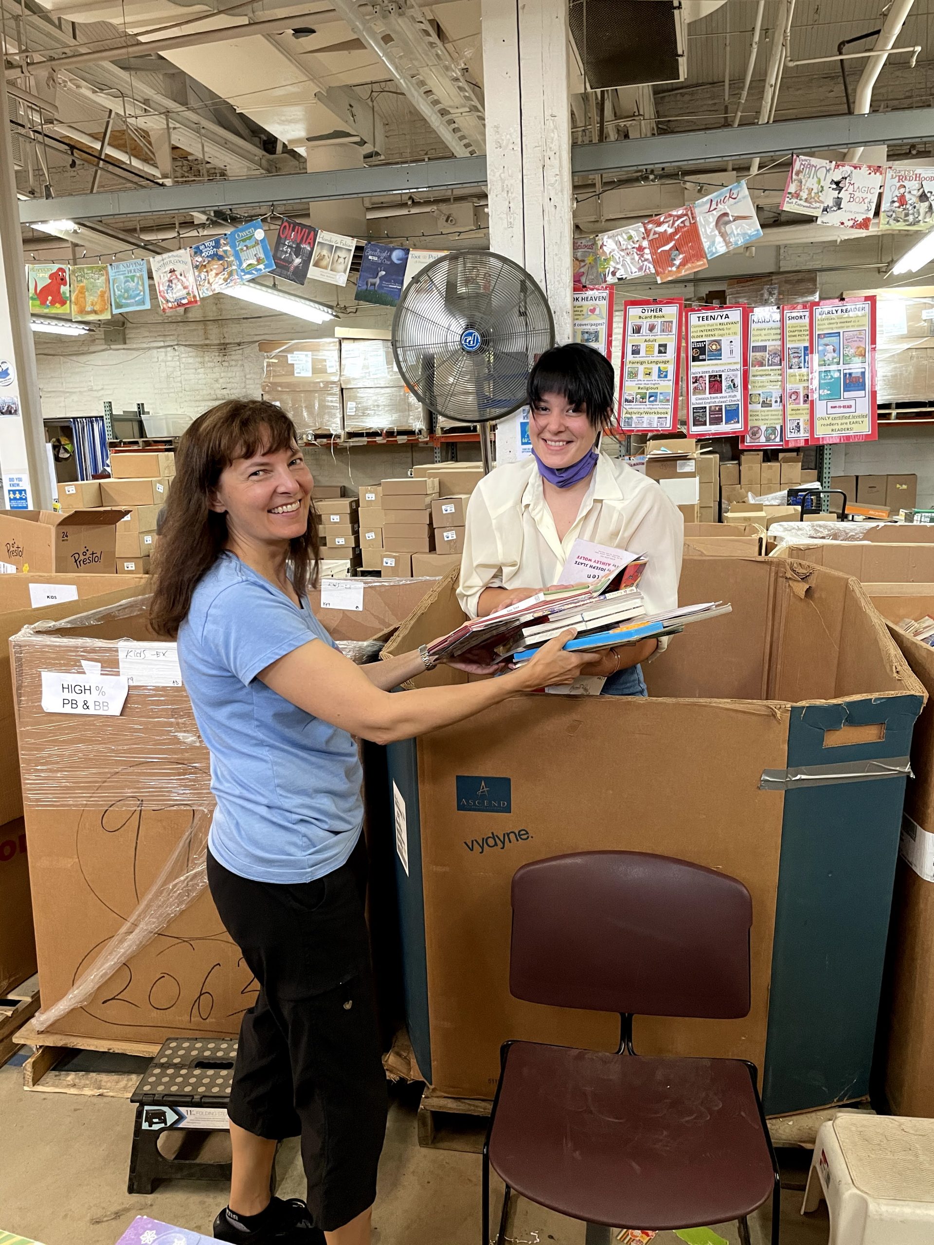 IMG_5850 Two volunteers sort books from a gaylord in the Cleveland Kids' Book Bank warehouse