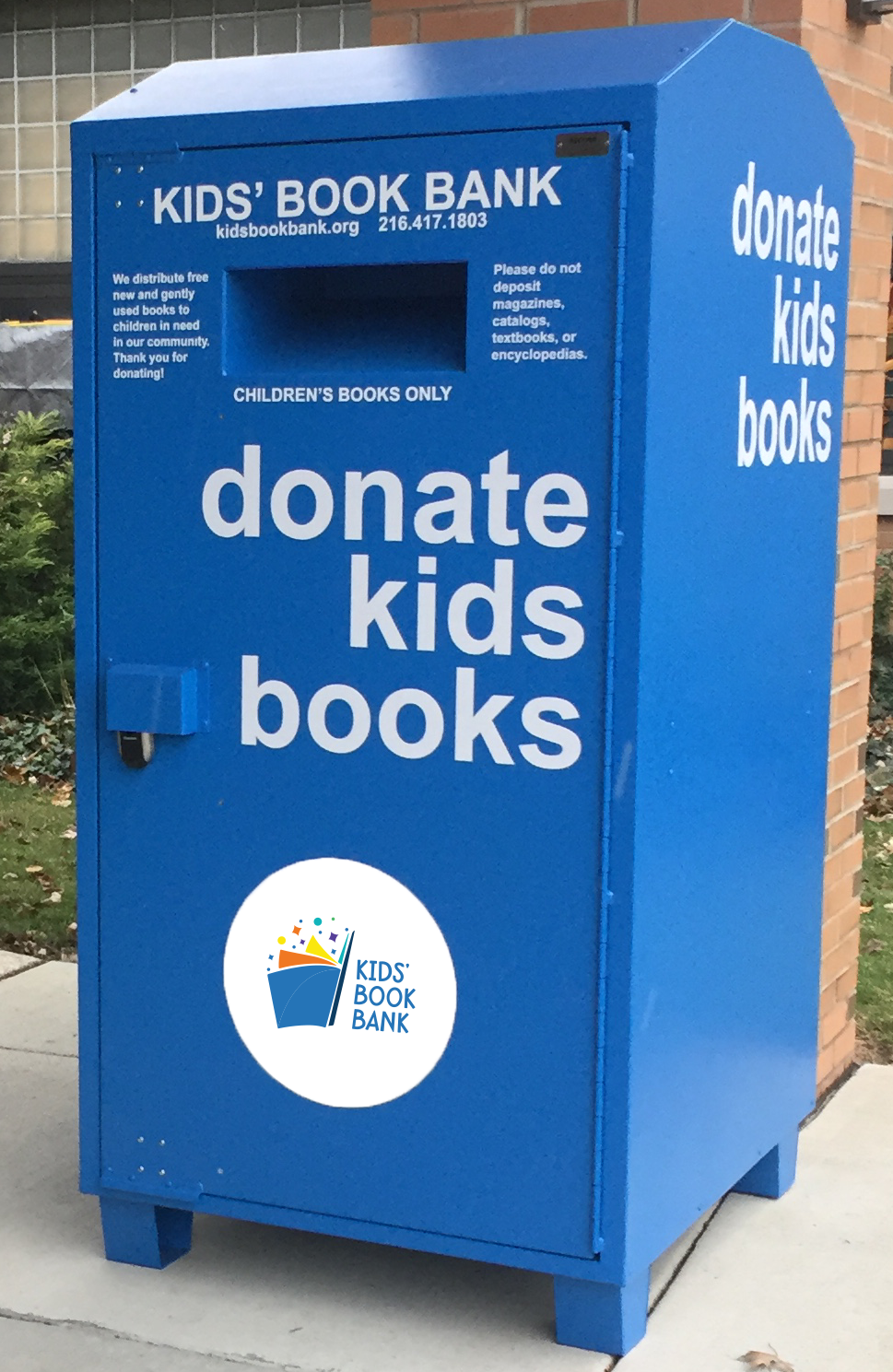 photo of large steel blue bin with Kids' Book Bank logo