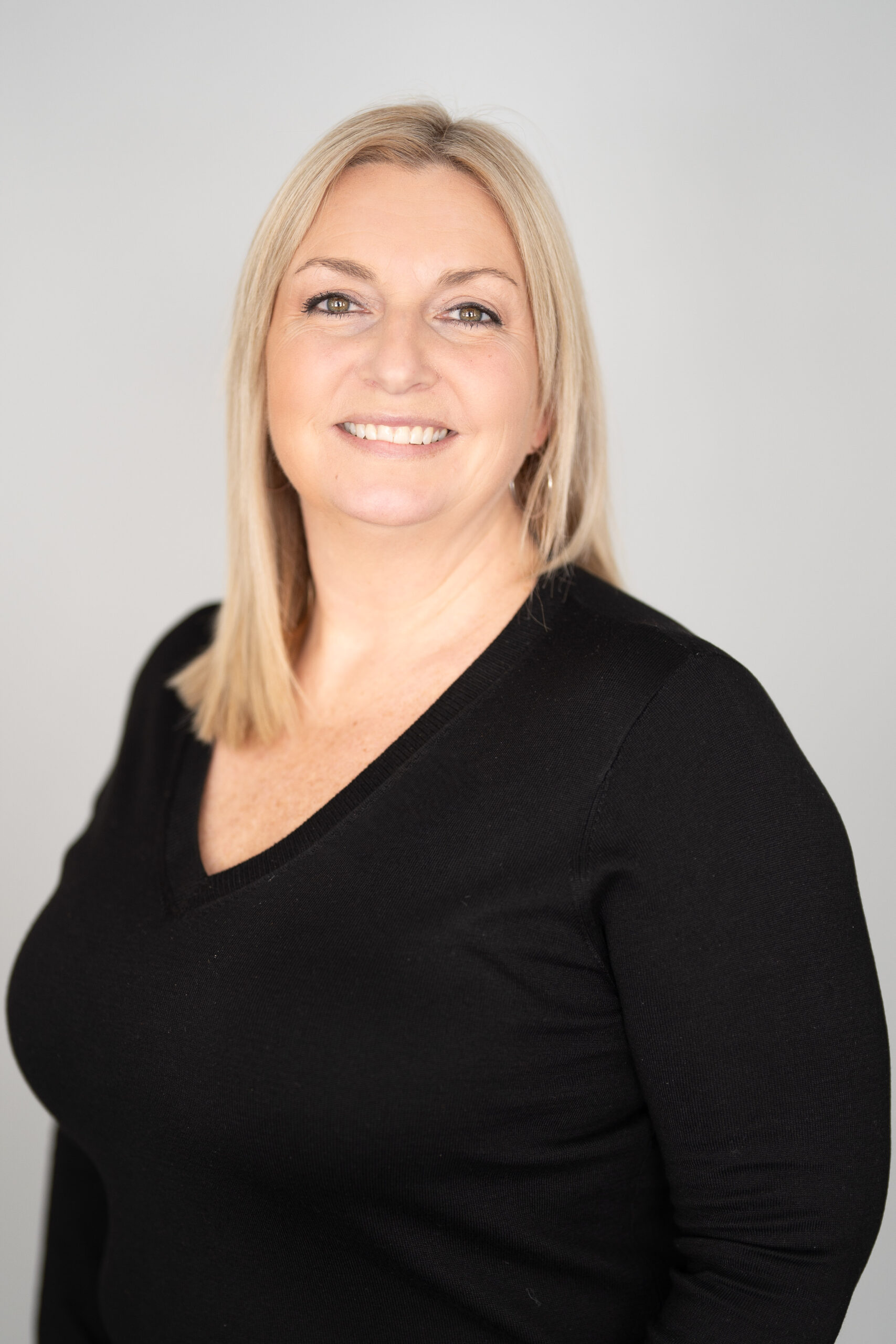 blond woman in black sweater