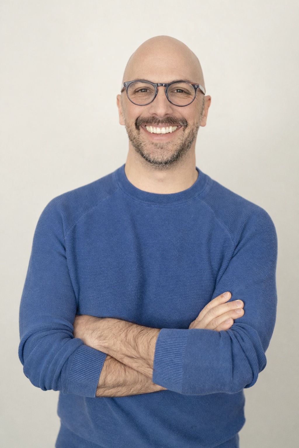 smiling man with glasses and mustache