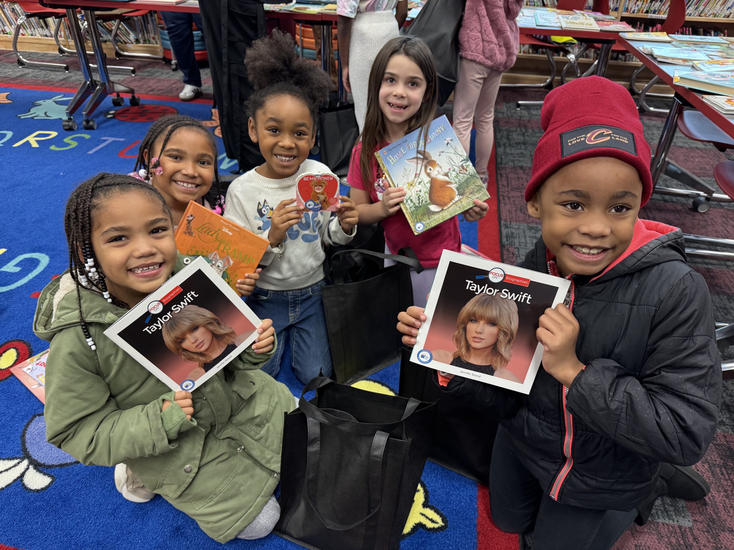 boy with glasses standing and reading a book