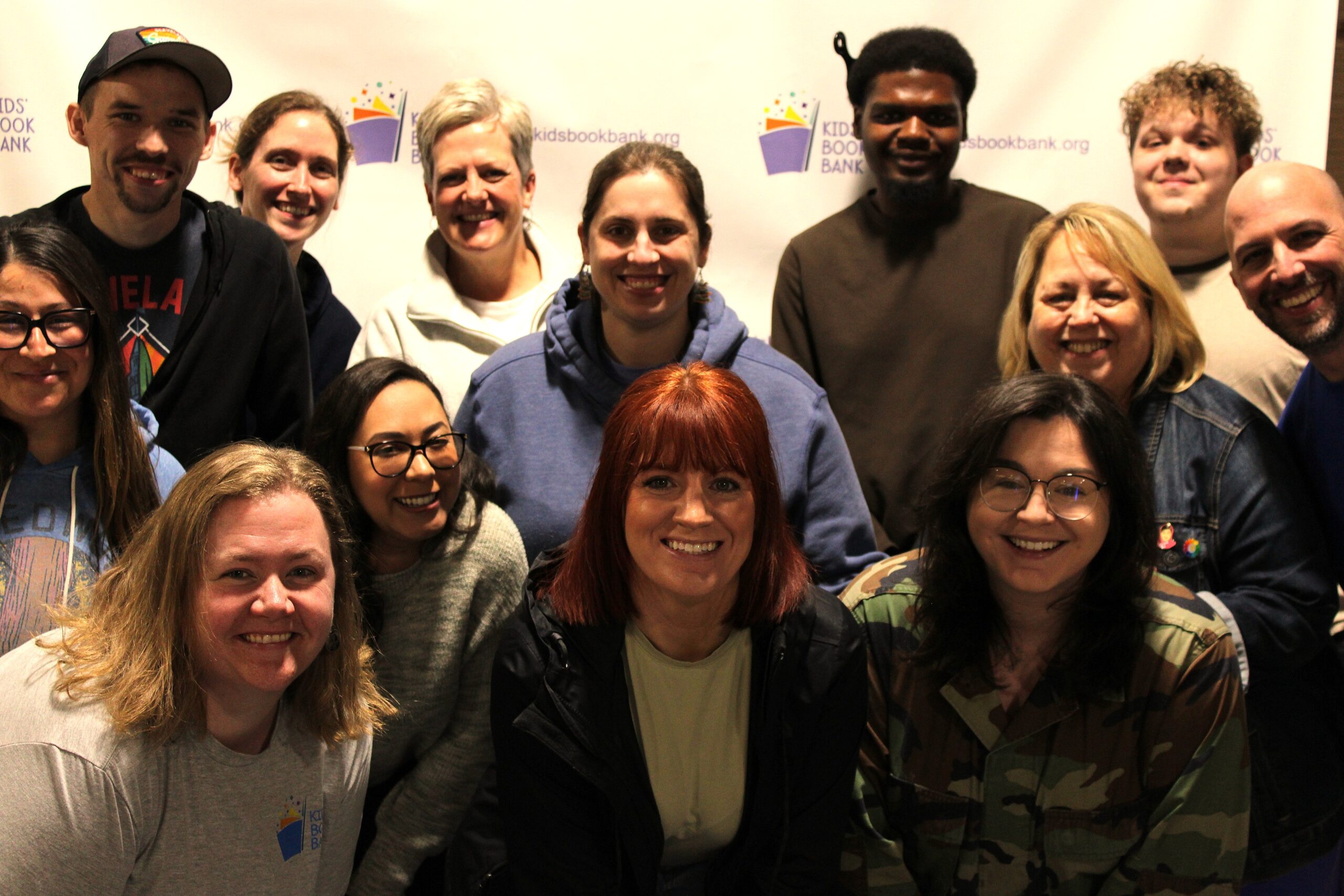 a group of people stand together for a photograph