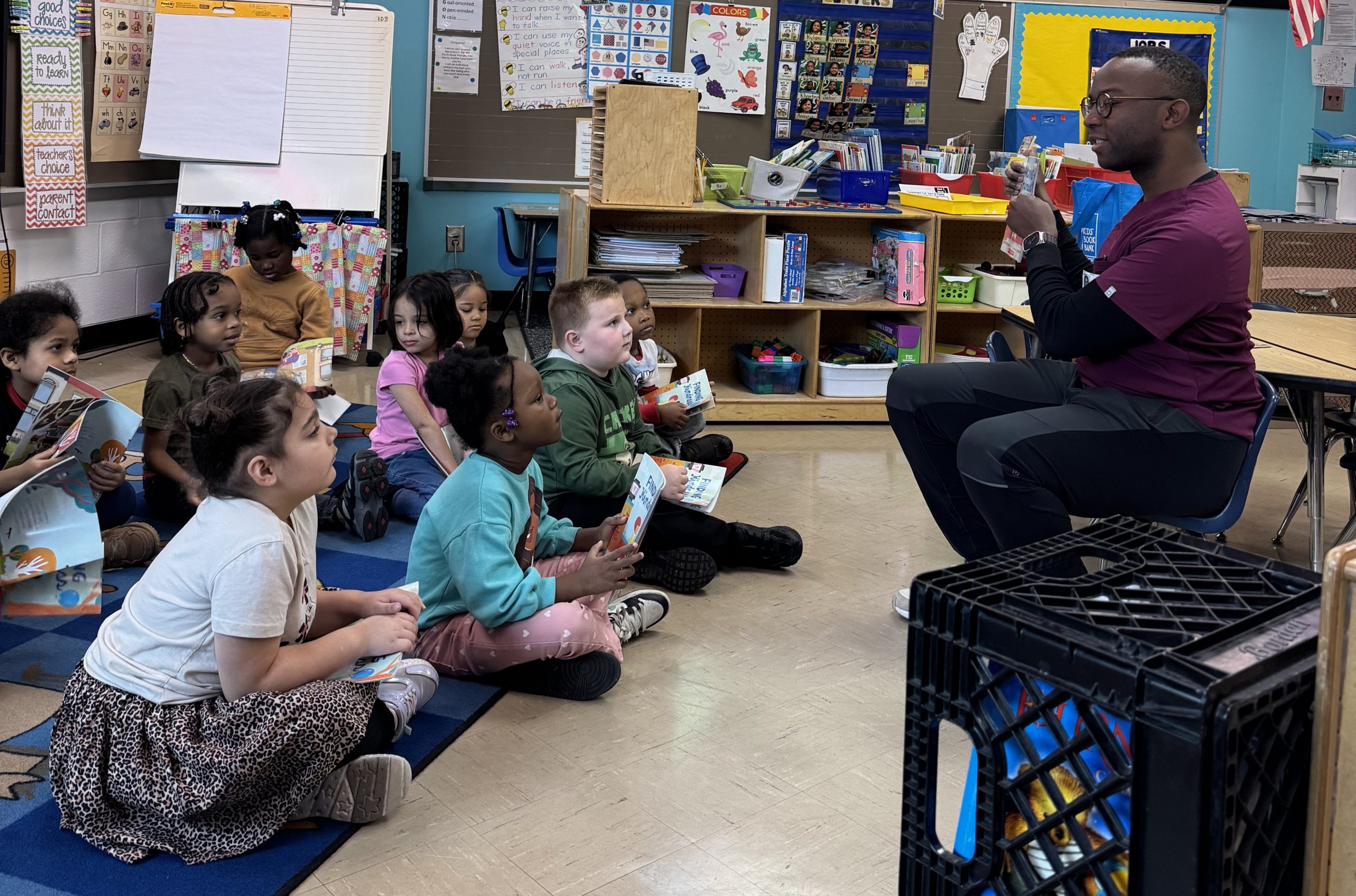 man reads to a classroom of seated students